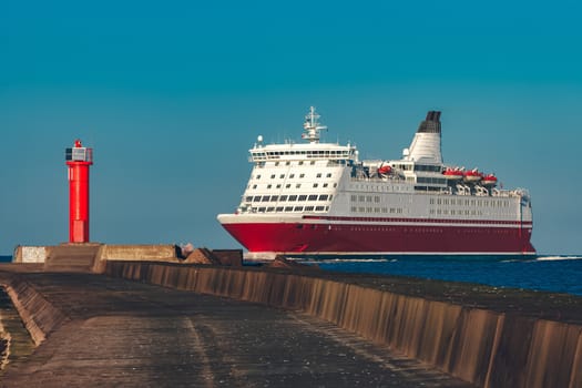 Red cruise liner. Large passenger ferry underway