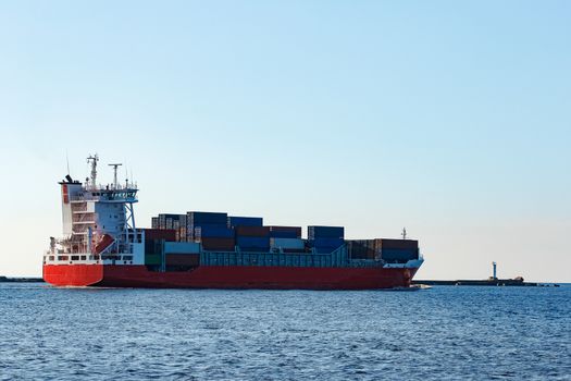 Red container ship sailing to the Baltic sea
