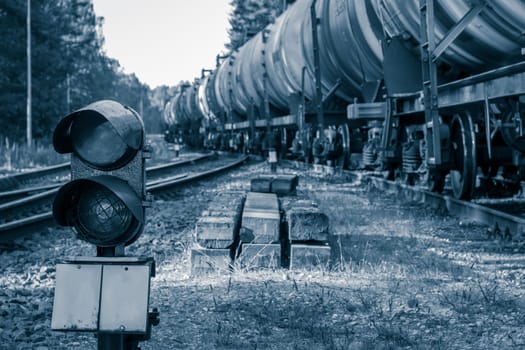 Railroad traffic light and freight train on behind