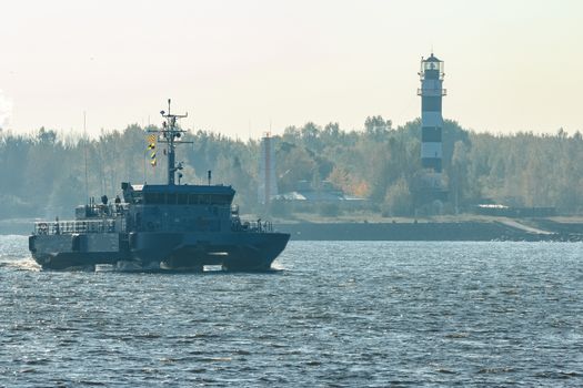 Small grey military ship moving from Baltic sea