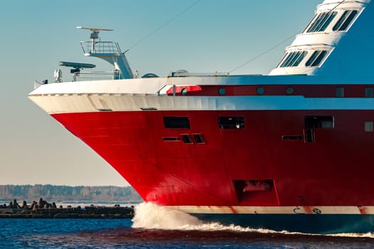 Red cruise liner. Large passenger ferry underway