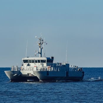 Small grey military ship moving from Baltic sea