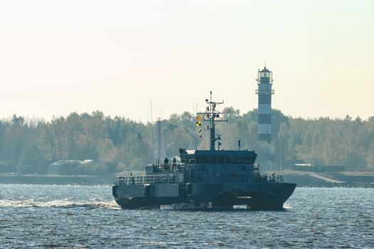 Small grey military ship moving from Baltic sea