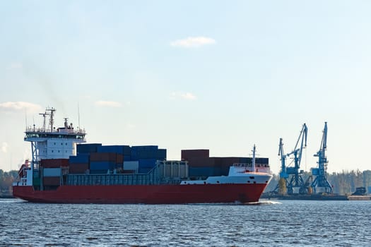 Red container ship sailing to the Baltic sea