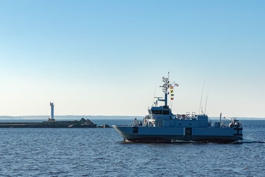Small grey military ship moving from Baltic sea