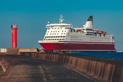 Red cruise liner. Large passenger ferry underway