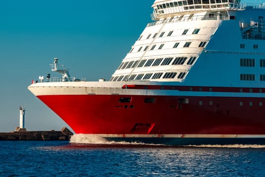 Red cruise liner. Large passenger ferry underway
