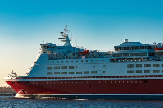 Red cruise liner. Large passenger ferry underway