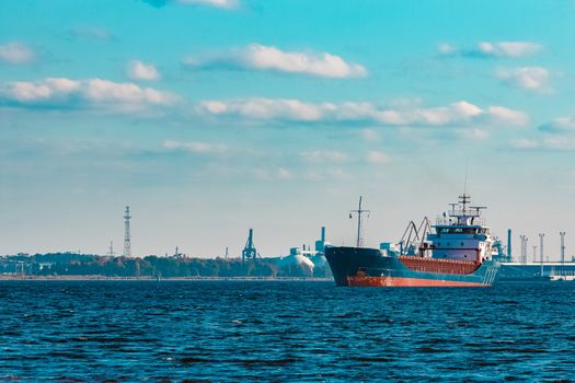 Blue cargo ship moving to the cargo port