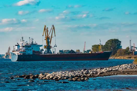 Blue cargo ship moving to the cargo port