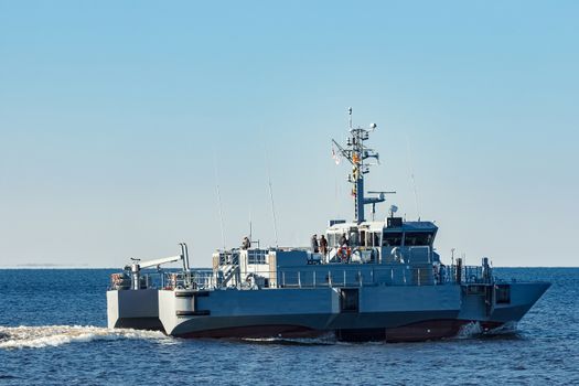 Small grey military ship moving from Baltic sea