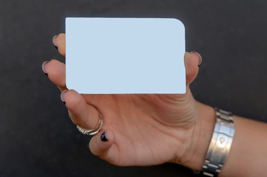 woman is holding a silver vip card