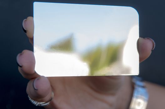 woman is holding a silver vip card