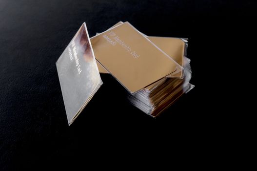 stack of golden vip cards on black leather surface