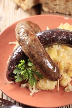 Blood sausage and white pudding with sauerkraut and potatoes