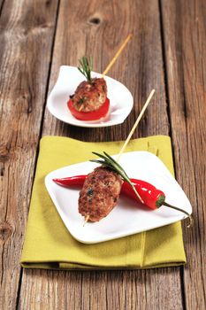 Minced meat kebabs on wooden skewers - still life