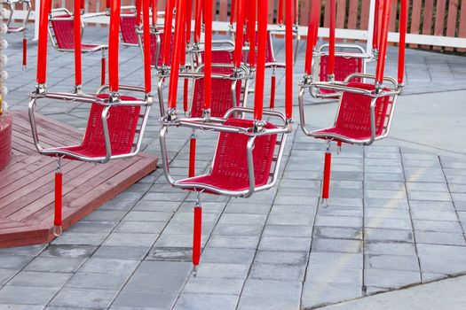 red seats of a carousel. close up