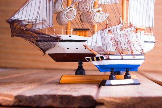 model of ships on the wooden table. travel concept