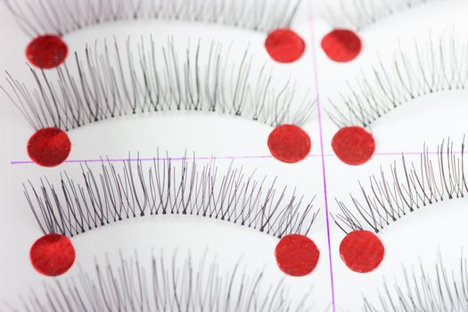 fmany pairs of alse eyelashes on white background