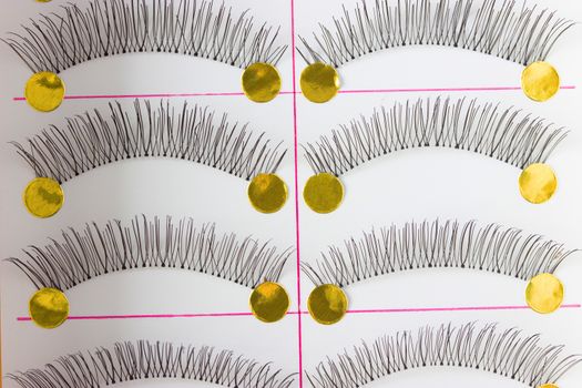 fmany pairs of alse eyelashes on white background