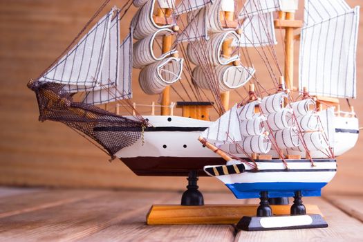 model of ships on the wooden table. travel concept