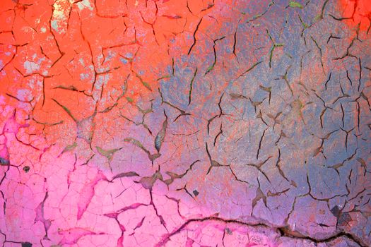 Close-up detail of cracked paint on wall. colorful