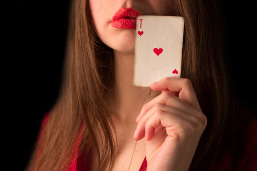 attractive girl with playing card. red dress and lips