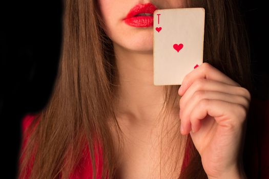attractive girl with playing card. red dress and lips