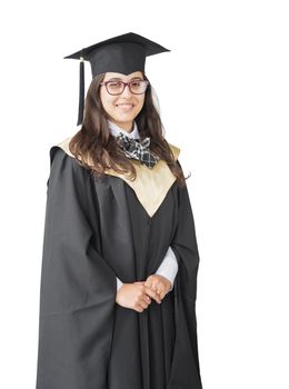 Young girl graduate of the University with eyeglasses, academic cap and black gown, standing isolated on white background