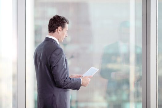 Businessman working with tablet and touching digital display