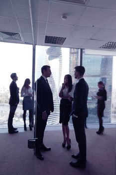 Business people talking in a conference room with city skyline