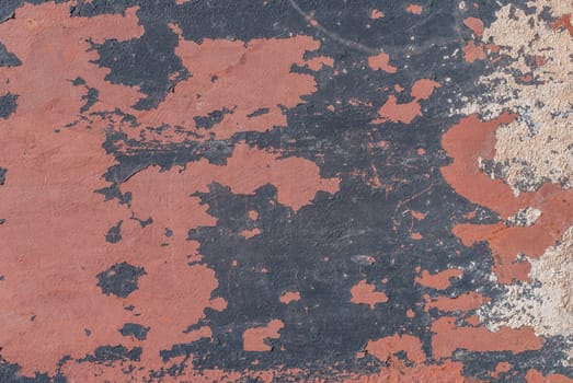 fragment of an iron surface is covered old paint, which has long been under the influence of different climatic conditions