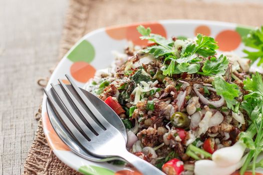 Spoons and ant eggs on a plate.