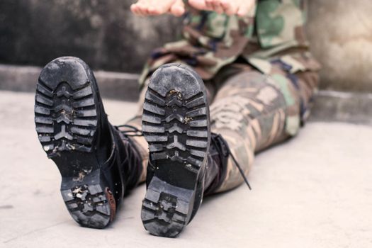 Female soldiers sitting on the floor.