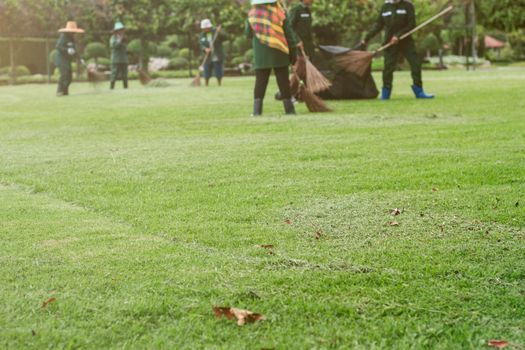 The lawns are cut and people are sweeping the floor.