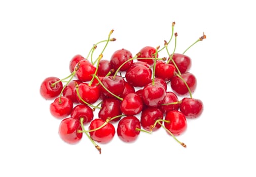 Small pile of the washed ripe sweet cherries with drops of the water on a light background
