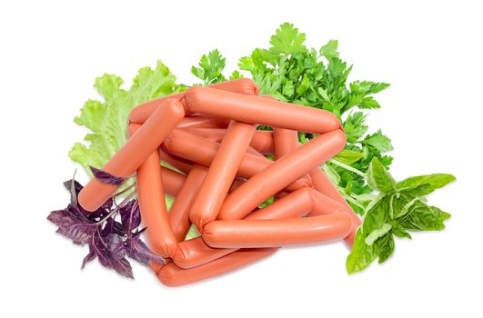 Pile of the uncooked frankfurters and twigs of purple basil, green basil, parsley and leaves of the lettuce on a light background

