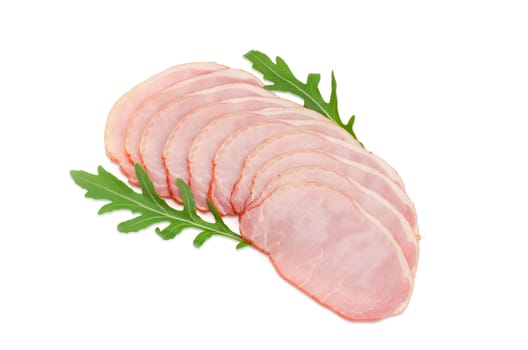 Sliced boiled smoked pork loin with arugula leaves on a light background
