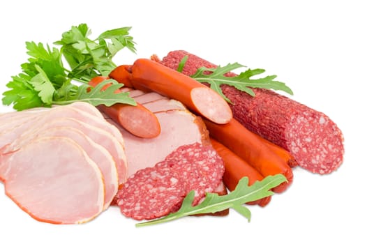 Sliced boiled smoked pork loin and ham, partly sliced salami and hunting sausages with arugula and parsley closeup on a light background

