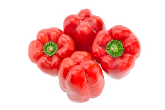 View from above of four fresh red bell peppers on a light background
