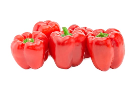 Several fresh red bell peppers on a light background
