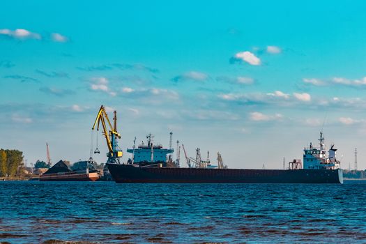 Blue cargo ship moving to the cargo port