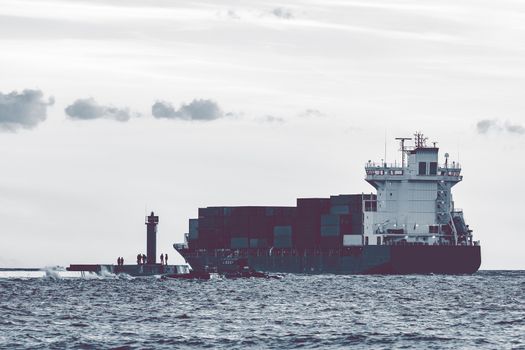 Full container ship leaving Riga and entering Baltic sea