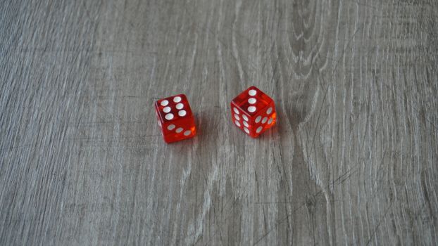 Throwing red dice on a grey background in the casino.