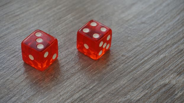 Throwing red dice on a grey background in the casino.