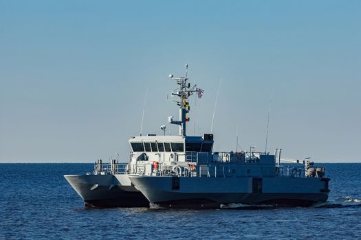 Small grey military ship moving from Baltic sea