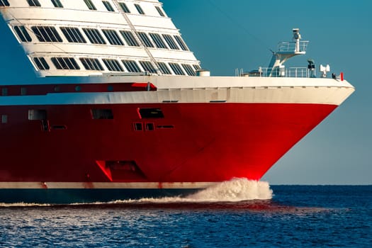 Red cruise liner. Large passenger ferry underway