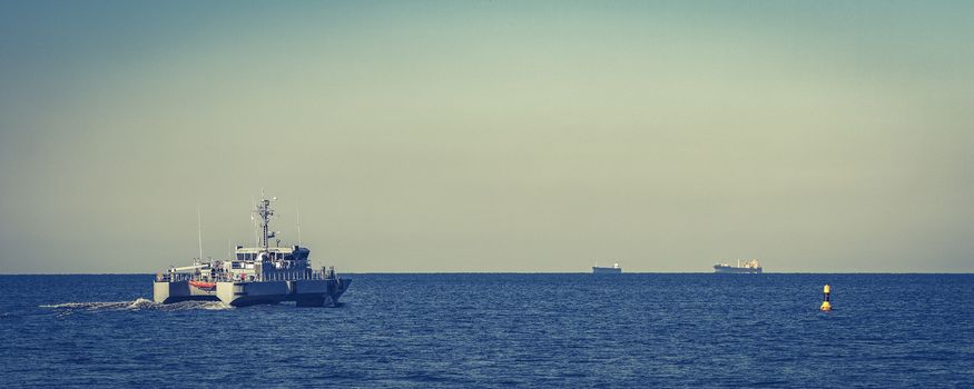 Small grey military ship moving from Baltic sea