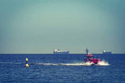Red pilot ship moving from the Baltic sea