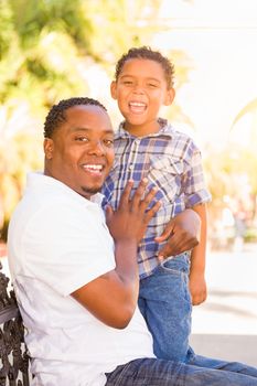 Mixed Race Son and African American Father Playing Outdoors Together.